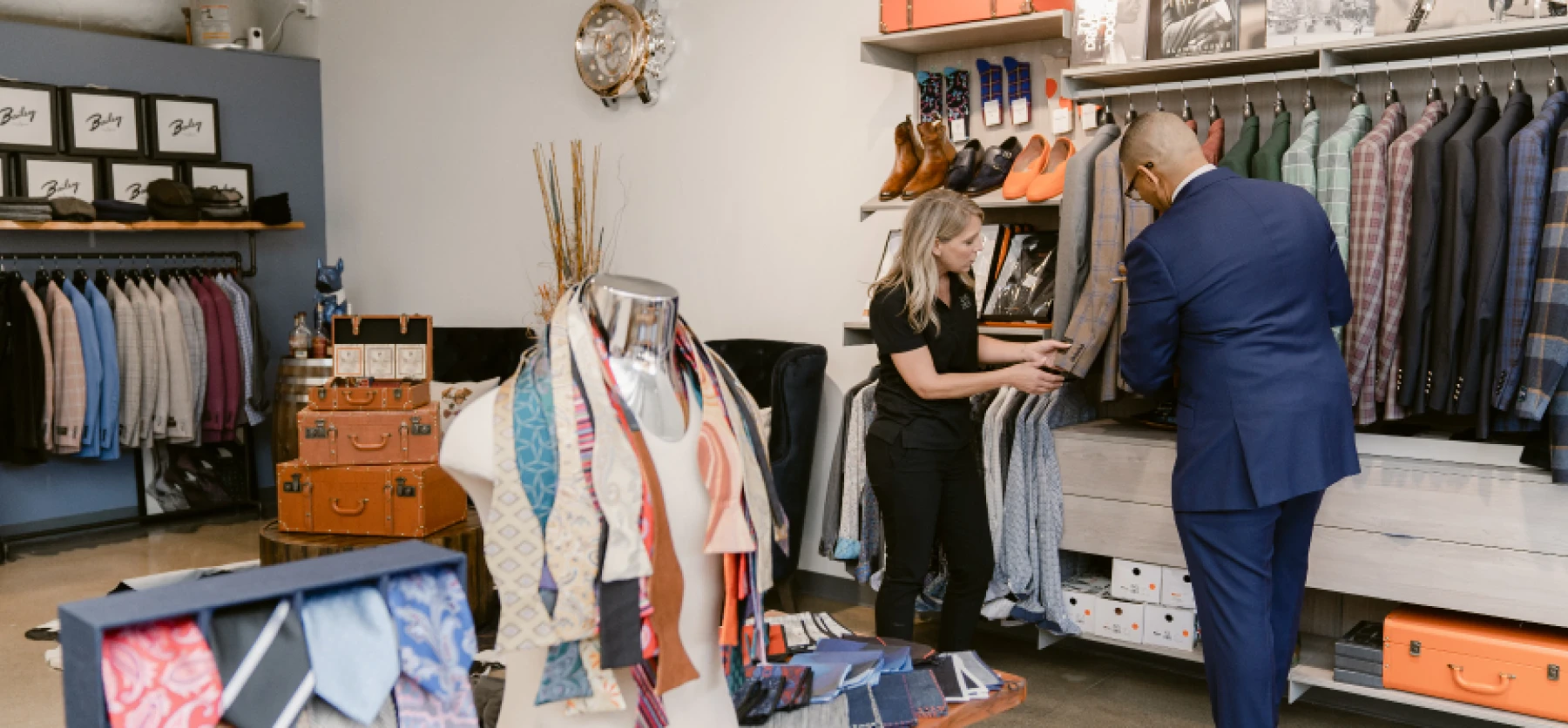 Business owner, Ne'gyle, showing customer options in his boutique in Detroit.